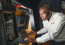 Energywise lab technician, Nathi Msweli, using state-of-art computer software that aids in evaluating performance of luminaires.